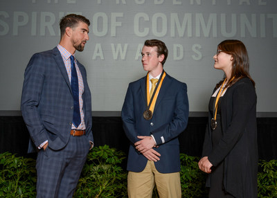 Olympic gold medalist Michael Phelps congratulates Adam Skelton, 17, of Anchorage (center) and Leena Robinson, 13, of Nenana (right) on being named Alaska's top two youth volunteers for 2017 by The Prudential Spirit of Community Awards. Adam and Leena were honored at a ceremony on Sunday, May 7 at the Smithsonian's National Museum of Natural History, where they each received a $1,000 award.