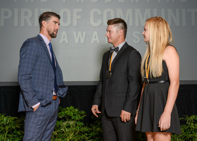 Olympic gold medalist Michael Phelps congratulates Emery Miller, 18 (center) and Lauren Basye, 13 (right), both of Gilbert, on being named Arizona's top two youth volunteers for 2017 by The Prudential Spirit of Community Awards. Emery and Lauren were honored at a ceremony on Sunday, May 7 at the Smithsonian's National Museum of Natural History, where they each received a $1,000 award.