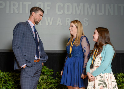 Olympic gold medalist Michael Phelps congratulates Emily Richey, 18, of Paris (center) and Gable Sloan, 11, of Fayetteville (right) on being named Arkansas' top two youth volunteers for 2017 by The Prudential Spirit of Community Awards. Emily and Gable were honored at a ceremony on Sunday, May 7 at the Smithsonian's National Museum of Natural History, where they each received a $1,000 award.