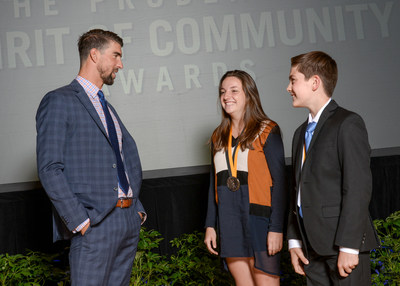 Olympic gold medalist Michael Phelps congratulates Annie Farrell, 18, of Miami (center) and Chase Hartman, 11, of Tampa (right) on being named Florida's top two youth volunteers for 2017 by The Prudential Spirit of Community Awards. Annie and Chase were honored at a ceremony on Sunday, May 7 at the Smithsonian's National Museum of Natural History, where they each received a $1,000 award.