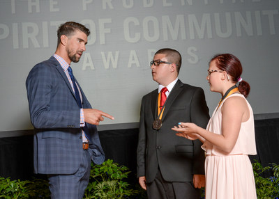 Olympic gold medalist Michael Phelps congratulates Joseph Thomasson, 15, of Lewiston (center) and Shelby Kettler, 10, of Pocatello (right) on being named Idaho's top two youth volunteers for 2017 by The Prudential Spirit of Community Awards. Joseph and Shelby were honored at a ceremony on Sunday, May 7 at the Smithsonian's National Museum of Natural History, where they each received a $1,000 award.