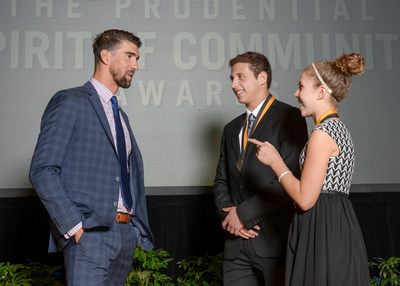 Olympic gold medalist Michael Phelps congratulates William Bauman, 17, of Grayslake (center) and Kayli Roe, 12, of Palatine (right) on being named Illinois' top two youth volunteers for 2017 by The Prudential Spirit of Community Awards. William and Kayli were honored at a ceremony on Sunday, May 7 at the Smithsonian's National Museum of Natural History, where they each received a $1,000 award.