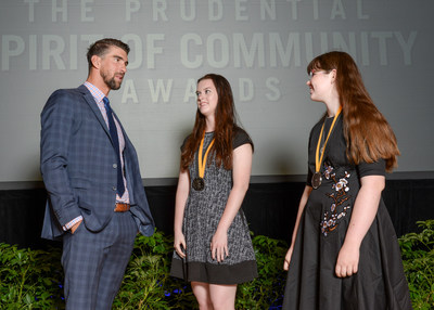 Olympic gold medalist Michael Phelps congratulates Grace McGowan, 18, of Overland Park (center) and Sydney Smith, 13, of Hiawatha (right) on being named Kansas' top two youth volunteers for 2017 by The Prudential Spirit of Community Awards. Grace and Sydney were honored at a ceremony on Sunday, May 7 at the Smithsonian's National Museum of Natural History, where they each received a $1,000 award.