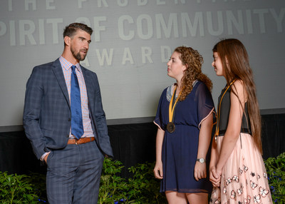 Olympic gold medalist Michael Phelps congratulates Lena Goldstein, 17, of Arnold (center) and Michaela West, 11, of Beltsville (right) on being named Maryland's top two youth volunteers for 2017 by The Prudential Spirit of Community Awards. Lena and Michaela were honored at a ceremony on Sunday, May 7 at the Smithsonian's National Museum of Natural History, where they each received a $1,000 award.