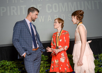 Olympic gold medalist Michael Phelps congratulates Miranda Mead, 17, of Plymouth (center) and Ariana Feygin, 12, of Excelsior (right) on being named Minnesota's top two youth volunteers for 2017 by The Prudential Spirit of Community Awards. Miranda and Ariana were honored at a ceremony on Sunday, May 7 at the Smithsonian's National Museum of Natural History, where they each received a $1,000 award.