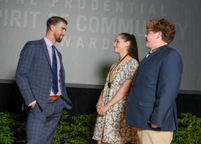 Olympic gold medalist Michael Phelps congratulates Victoria Kosinski, 18, of Kinston (center) and Caleb Lumpkin, 14, of Winston-Salem (right) on being named North Carolina's top two youth volunteers for 2017 by The Prudential Spirit of Community Awards. Victoria and Caleb were honored at a ceremony on Sunday, May 7 at the Smithsonian's National Museum of Natural History, where they each received a $1,000 award.