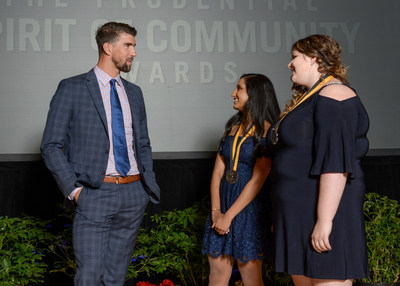 Olympic gold medalist Michael Phelps congratulates Nidhi Mahale, 17, of Fargo (center) and Annabelle Barcomb, 14, of Minot (right) on being named North Dakota's top two youth volunteers for 2017 by The Prudential Spirit of Community Awards. Nidhi and Annabelle were honored at a ceremony on Sunday, May 7 at the Smithsonian's National Museum of Natural History, where they each received a $1,000 award.