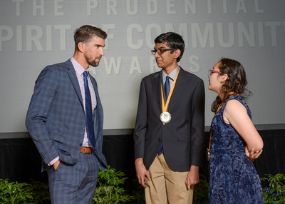 Olympic gold medalist Michael Phelps congratulates Pranit Nanda, 17, of Reno (center) and Athena Morales, 13, of Las Vegas (right) on being named Nevada's top two youth volunteers for 2017 by The Prudential Spirit of Community Awards. Pranit and Athena were honored at a ceremony on Sunday, May 7 at the Smithsonian's National Museum of Natural History, where they each received a $1,000 award.