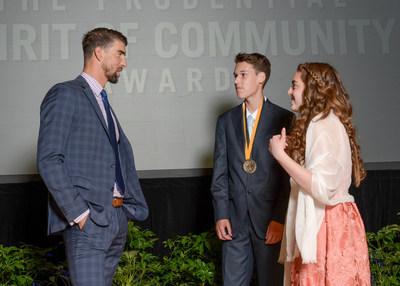 Olympic gold medalist Michael Phelps congratulates Bradley Ferguson, 16, of Northfield (center) and Kierstyn Kuehnle, 13, of Ocean City (right) on being named New Jersey's top two youth volunteers for 2017 by The Prudential Spirit of Community Awards. Bradley and Kierstyn were honored at a ceremony on Sunday, May 7 at the Smithsonian's National Museum of Natural History, where they each received a $1,000 award.