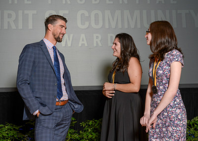 Olympic gold medalist Michael Phelps congratulates Ariana DeMattei, 16, of Center Moriches (center) and Victoria Bonavita, 13, of North Babylon (right) on being named New York's top two youth volunteers for 2017 by The Prudential Spirit of Community Awards. Ariana and Victoria were honored at a ceremony on Sunday, May 7 at the Smithsonian's National Museum of Natural History, where they each received a $1,000 award.