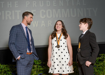 Olympic gold medalist Michael Phelps congratulates Anneliese Taggart, 16, of Vermillion (center) and Donnie Stoltz, 13, of Sioux Falls (right) on being named South Dakota's top two youth volunteers for 2017 by The Prudential Spirit of Community Awards. Anneliese and Donnie were honored at a ceremony on Sunday, May 7 at the Smithsonian's National Museum of Natural History, where they each received a $1,000 award.