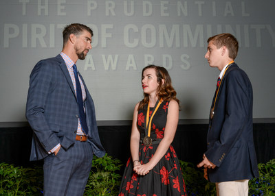 Olympic gold medalist Michael Phelps congratulates Mallory Fundora, 17, of Clarksville (center) and Wills McAdams, 14, of Murfreesboro (right) on being named Tennessee's top two youth volunteers for 2017 by The Prudential Spirit of Community Awards. Mallory and Wills were honored at a ceremony on Sunday, May 7 at the Smithsonian's National Museum of Natural History, where they each received a $1,000 award.