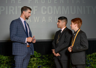 Olympic gold medalist Michael Phelps congratulates Ryan Almusawi, 17, of Fort Worth (center) and Micah Pinson, 12, of Shady Shores (right) on being named Texas' top two youth volunteers for 2017 by The Prudential Spirit of Community Awards. Ryan and Micah were honored at a ceremony on Sunday, May 7 at the Smithsonian's National Museum of Natural History, where they each received a $1,000 award.