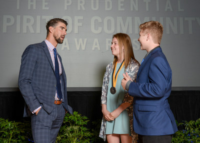 Olympic gold medalist Michael Phelps congratulates Patricia Bell, 18, of Kirkland (center) and Tyler Fiorino, 13, of Spokane (right) on being named Washington's top two youth volunteers for 2017 by The Prudential Spirit of Community Awards. Patricia and Tyler were honored at a ceremony on Sunday, May 7 at the Smithsonian's National Museum of Natural History, where they each received a $1,000 award.