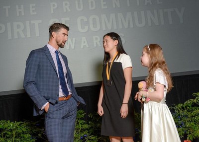 Olympic gold medalist Michael Phelps congratulates Amanda Yang, 16, of Dresher (center) and Lorelei McIntyre-Brewer, 11, of Duncannon (right) on being named Pennsylvania's top two youth volunteers for 2017 by The Prudential Spirit of Community Awards. Amanda and Lorelei were honored at a ceremony on Sunday, May 7 at the Smithsonian's National Museum of Natural History, where they each received a $1,000 award.