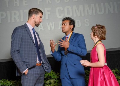 Olympic gold medalist Michael Phelps congratulates Amal Bhatnagar, 18, of Duluth (center) and Kelsey Norris, 13, of Bonaire (right) on being named Georgia's top two youth volunteers for 2017 by The Prudential Spirit of Community Awards. Amal and Kelsey were honored at a ceremony on Sunday, May 7 at the Smithsonian's National Museum of Natural History, where they each received a $1,000 award.