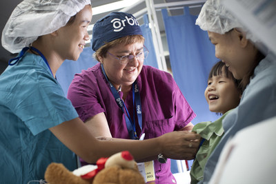 Orbis volunteer ophthalmic nurse, Cherelyn Victor, RN, works in the Flying Eye Hospital recovery room to prepare Minh, 4, for treatment during the Flying Eye Hospital's previous trip to Vietnam. Learn more: orbis.org (photo: Geoff Oliver Bugbee/Orbis).