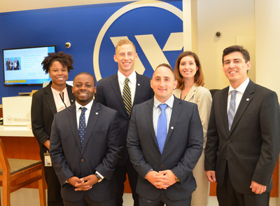 In the photo, from the left in the rear, at a Webster Bank banking center in Waterbury, Connecticut, are the following Webster bankers: Ebony Hargrove, Ian Milne, and Danielle Fernald. In front, from left: Elijah Coleman, Anthony Sidera, and Philip Thierman.