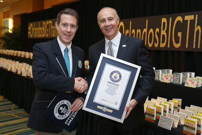 Philip Robertson, GUINNESS WORLD RECORDS adjudicator and George Aguel, President and CEO of Visit Orlando, celebrate the declaration of Visit Orlando as a GUINNESS WORLD RECORDS title holder as part of the launch of a new thank you campaign, on May 11 in Orlando, Fla. (Photo Credit: Alex Menendez)