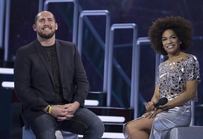 Dillon Carman and host Arisa Cox share a laugh on stage watching his goodbye messages after his eviction on Big Brother Canada (CNW Group/Global Television)
