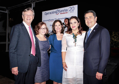 From left to right: Operation Smile Co-Founder and CEO Dr. Bill Magee, Operation Smile Senior Executive Advisor Beth Marshall, and Chair of the Board of Directors of Operation Smile Honduras Ana Kafie pose with the President of Honduras Juan Orlando Hernandez and the First Lady Ana Garcia de Hernandez at Operation Smile Honduras' 20th anniversary celebration.