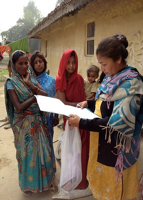 A Nepalese member of an international research team surveys villagers in the subtropical plains of southern Nepal in Asia. The researchers report in The Lancet Infectious Diseases vaccinating pregnant mothers year-round against flu in this resource-challenged region reduced infant flu virus infection rates and increased birth weights.