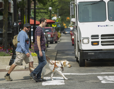 Leader Dogs for the Blind: client crossing street during training.