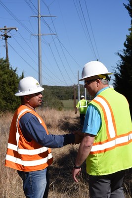 Manager of BEC Fiber, Shane Schmidt, works with a contractor to install the fiber optic cable that will upgrade Bandera Electric Cooperative's distribution system to a smart grid.