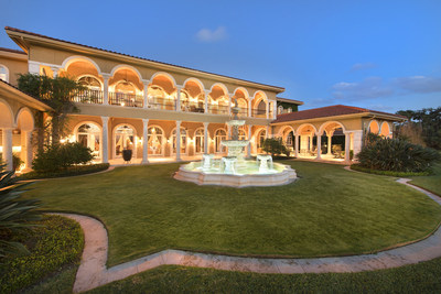 Platinum Luxury Auctions has announced the upcoming sale of this spectacular waterfront mansion located in Daytona Beach, Florida. Built and owned by the France family, the founders of NASCAR, the property offers 3.8 acres and more than 325 feet of water frontage on Daytona’s Halifax River. Though not previously offered for sale, the home was appraised for $13.8 million. Discover more at RiverfrontLuxuryAuction.com. Pictured: The rear loggia and courtyard fountain at dusk.