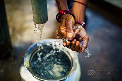 A woman washes her hands in clean water from a well in India.