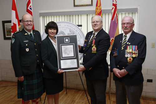 From left: Kirk MacRae, Member of the Royal Canadian Mint Board of Directors and Ginette Petitpas Taylor, MP (Moncton - Riverview - Dieppe) present the 75th Anniversary of the Battle of Dieppe silver collector coin to Robert Dupuis, President, Moncton Branch of the Royal Canadian Legion (Moncton, NB, May 25, 2017) (CNW Group/Royal Canadian Mint)