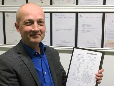 Dr. Chris Hilton, Chief Technology Officer, holding the 100th global patent recently awarded Protean Electric, the global electric drive technology company.