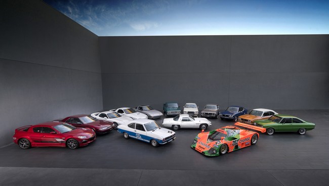 Mazda celebrates 50 years of innovation, starting with the 1967 Cosmo Sport 110S. L to R: Mazda RX-8, Eunos Cosmo, FD Mazda RX-7, FC Mazda RX-7, FB Mazda RX-7, Mazda Rotary Pickup, Mazda RX-5 Cosmo, Mazda RX-4, Mazda RX-3, Mazda RX-2 and Mazda R100. Middle: 1973 Mazda RX-2 racecar, 1967 Mazda Cosmo Sport 110S and 1989 Mazda 767B.