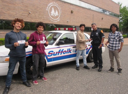 Suffolk County, New York, police officer “tickets” Brentwood High School teens for attending an after school gaming program, created in partnership with the Suffolk County Police Department and the Brentwood Public Library. The ticket, actually a 7-Eleven Operation Chill coupon good for a small free Slurpee drink, rewards the students for participating in the program that encourages relationship building between youth and local police officers.
