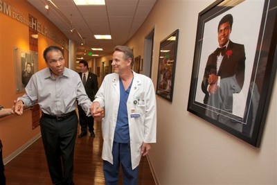 Results from a new study by Barrow Neurological Institute show that while 90 percent of Americans said they most remember Ali for his boxing career, more than 60 percent recall the dignity and grace with which he battled Parkinson’s disease over the last three decades of his remarkable life. Here, Muhammad Ali walks the halls of the Muhammad Ali Parkinson Center with Robert Spetzler, MD, the director of Barrow Neurological Institute.