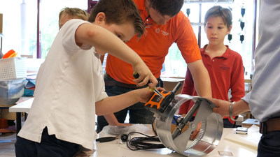 Cyprus students work with HVAC technicians to install the 75F control system.