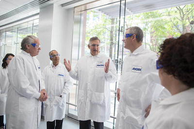 Robert A. Bradway, Chairman and Chief Executive Officer of Amgen, center, explains the company's commitment to Cambridge as one of its core research hubs to Senator Edward Markey, left, Shekar Ganesa, Executive Director of Process Development, Massachusetts Governor Charlie Baker and  Aine Hanly, Vice President, Process Development and Amgen Massachusetts Site Head, on Friday, June 2, 2017, in Cambridge, Mass. (Scott Eisen/AP Images for Amgen)
