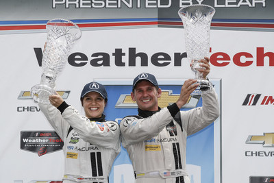 Michael Shank Racing drivers Katherine Legge, left, and Andy Lally celebrate the first victory of the Acura NSX GT3 in international sports car racing Saturday in Detroit, Michigan.