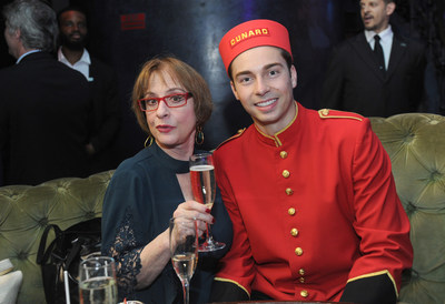 Patti LuPone enjoys a glass of champagne alongside Cunard bellman.