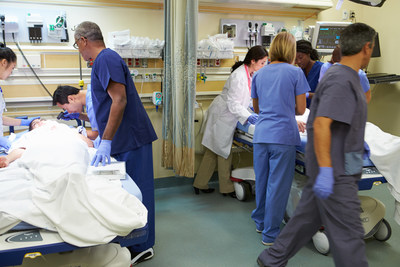 Medical Team Working On Multiple Patients In Emergency Room