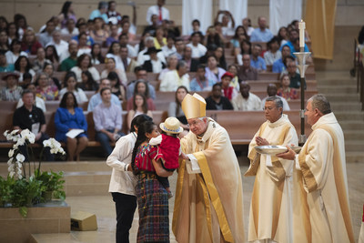 Mayan family of Guatemala receives a blessing from Archbishop José H. Gomez during the presentation of the gifts at the Mass in Recognition of All Immigrants at the Cathedral of Our Lady of the Angels in Los Angeles on Sunday, June 18, 2017.