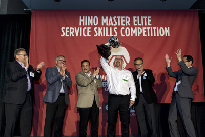 Billy Stanley of Rush Truck Center - Houston raises the cup as the winner of Hino Truck's 2017 National Master Elite Service Skills Competition.