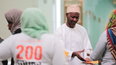 Imam of The Islamic Cultural Center of New York, Chernor S. Jalloh receiving cards from DoSomething.org & buildOn students for "Sincerely, Us" campaign. Photo Credit: Chris Alfonso for DoSomething.org