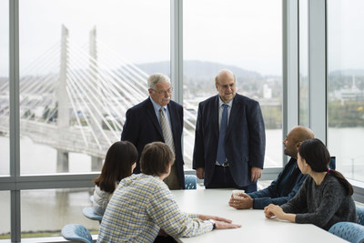 Mike Heller, Ph.D., and Sadik Esener, Ph.D., meet with members of the CEDAR team. (OHSU)