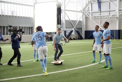 Gabriel Pacca from Woo the Boards practices his balance with Manchester City players during Wix's commercial shoot