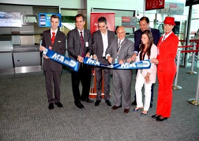 From left: GMCVB Executive Vice President Rolando Aedo (second from left), Miami-Dade Aviation Department Chief of Staff Joseph Napoli (center) and Avianca Brasil staff and flight crew cut the ribbon at the June 26 MIA celebration. Click here for hi-res images http://news.miami-airport.com/mia-celebrates-launch-of-so-paulo-service-by-avianca-brasil/