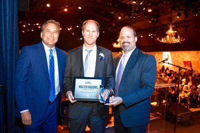 Affinity Gaming CFO Walter Bogumil (center), receives Financial Executive of the Year in Gaming/Hospitality award from KSNV anchor Dana Wagner (left) and FEI Las Vegas Chapter President Gary Vecchiarelli (right)