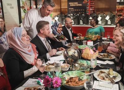 Loblaws® Maple Leaf Gardens staff and President's Choice® host #EatTogether dinner with Purpose, UNICEF Global and 12 new Canadian residents. (CNW Group/Loblaw Companies Limited)