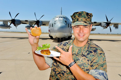 Military personnel enjoy ThankYouBurgers from Carnival Cruise Line during the first social media powered barbecue.