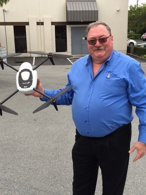 Glenn Smith, Vice President, CRU Adjusters, holds a Kespry Drone.